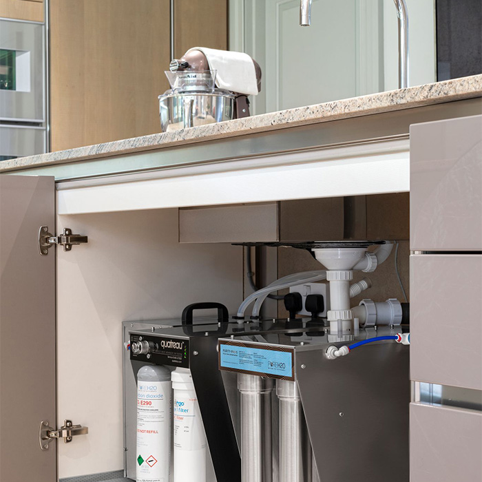 a water filtration system underneath a kitchen sink